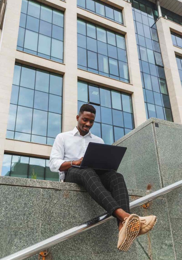 handsome-young-businessman-working-with-laptop-out-778RPJZ-p6sspsluf3m6i070x175t77ezggfzok9eti66azj80 (1)